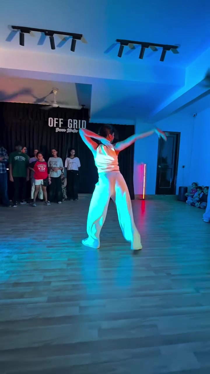 Dancer performing under blue light at Off Grid